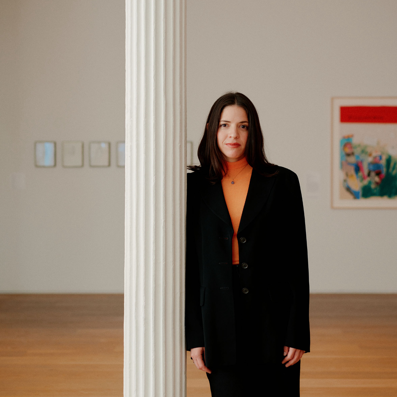 woman standing next to column