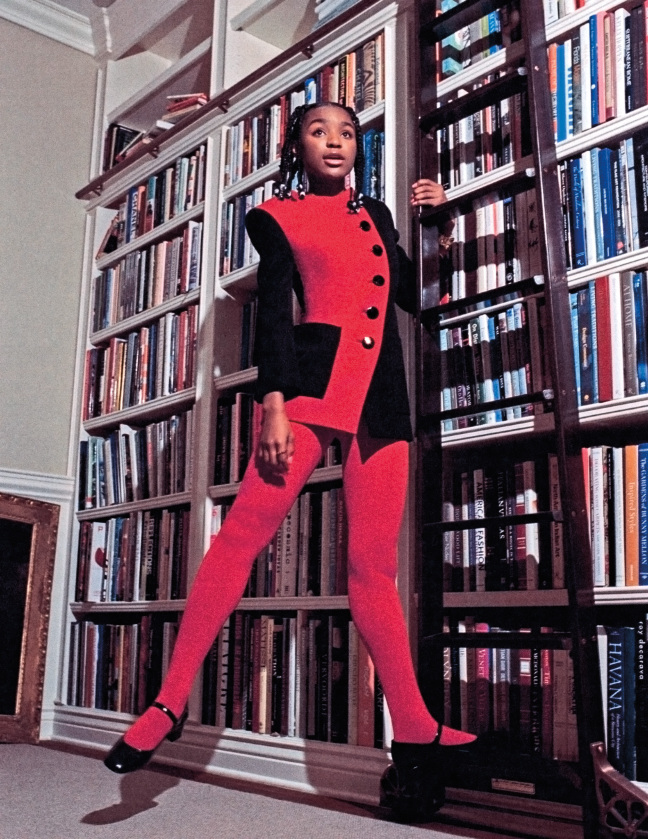 girl standing on bookcase ladder