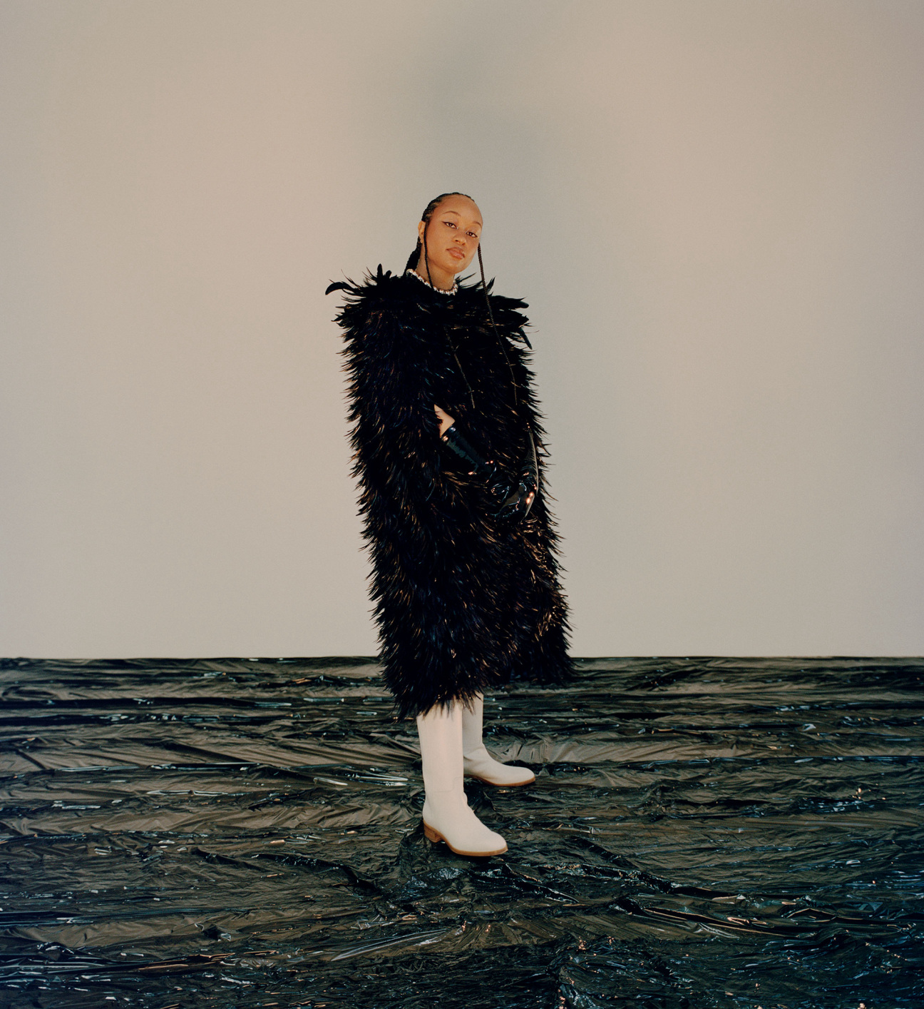 woman standing in feather coat