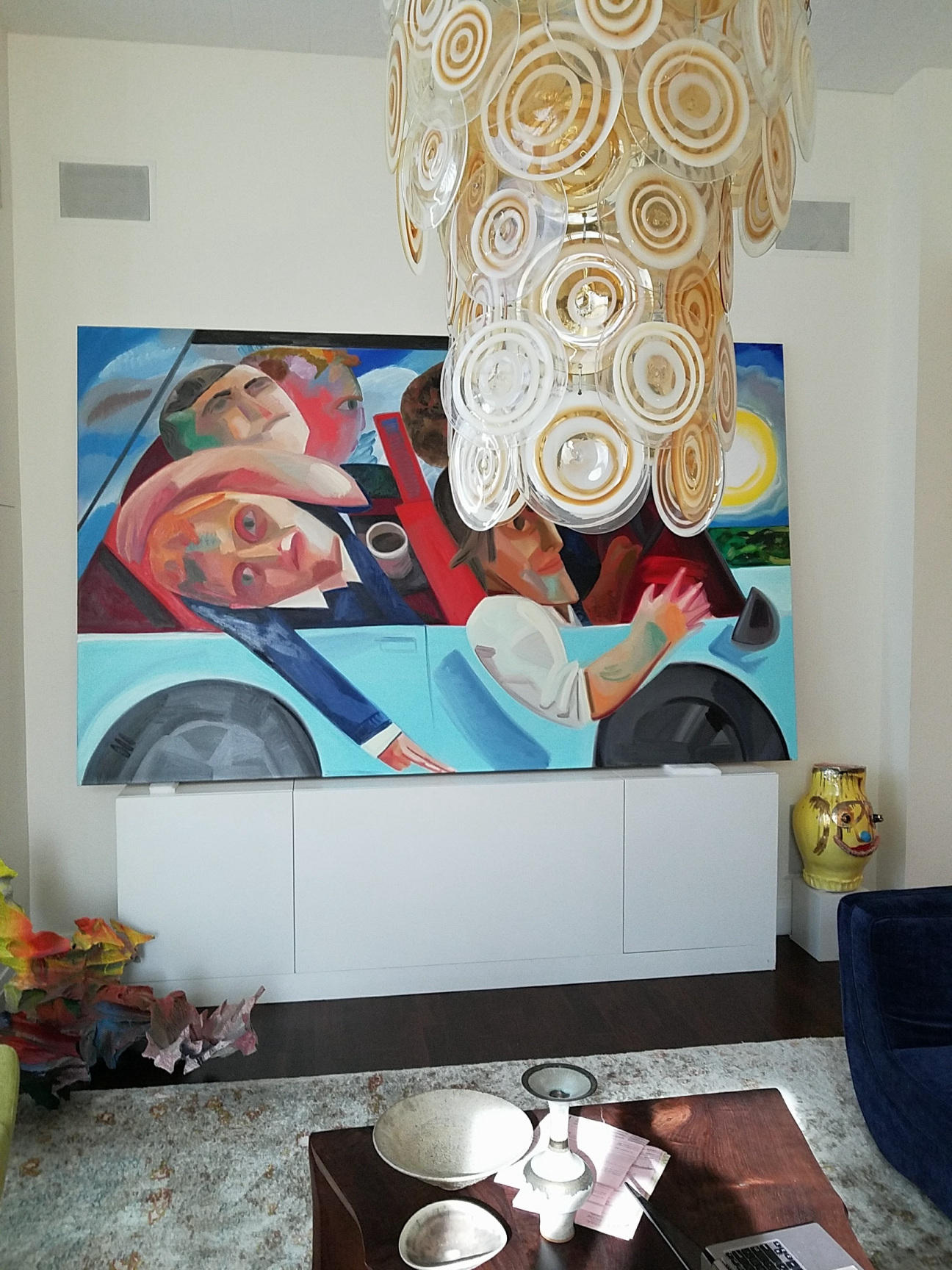Large colorful painting hanging in a home.