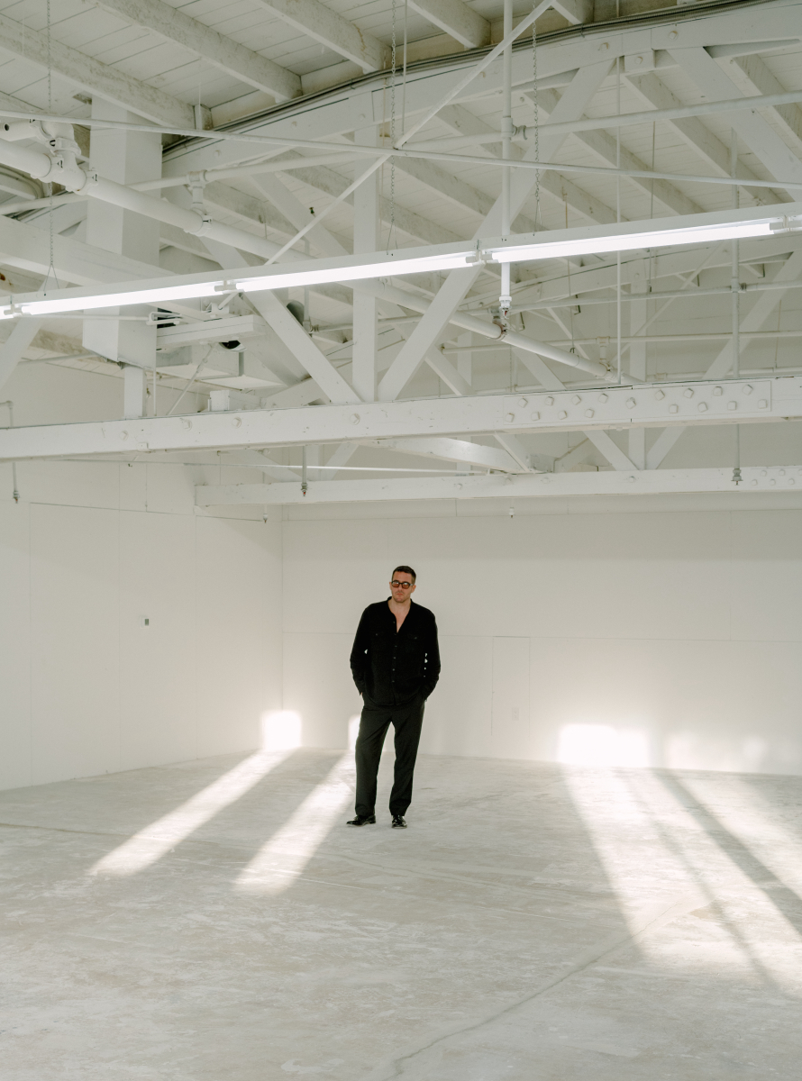 man standing in empty gallery