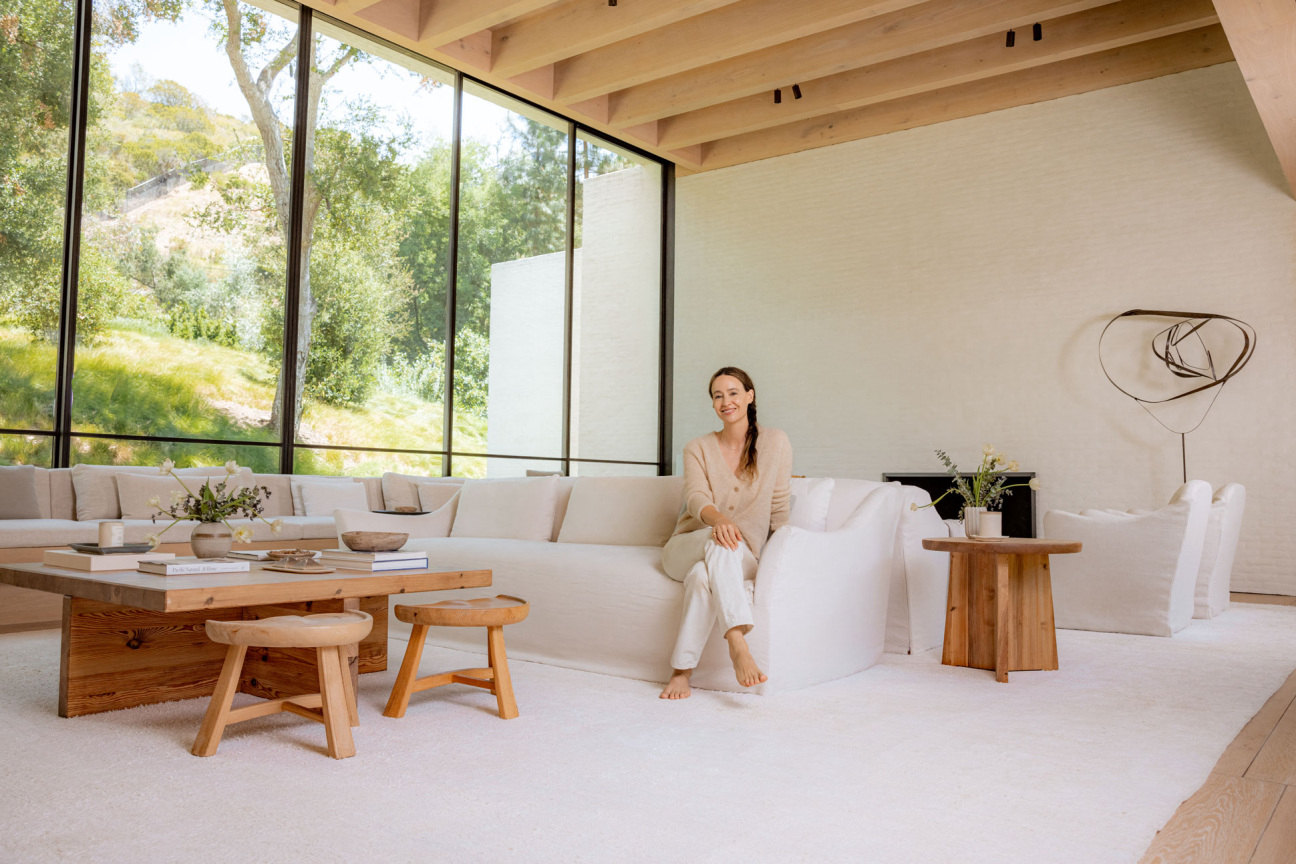 woman sits on couch