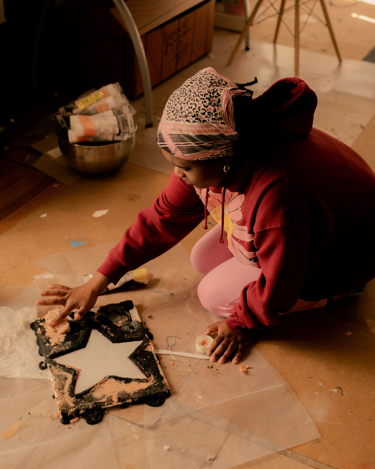 woman on floor making art