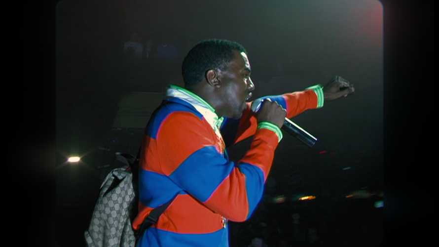 man on stage with fist raised