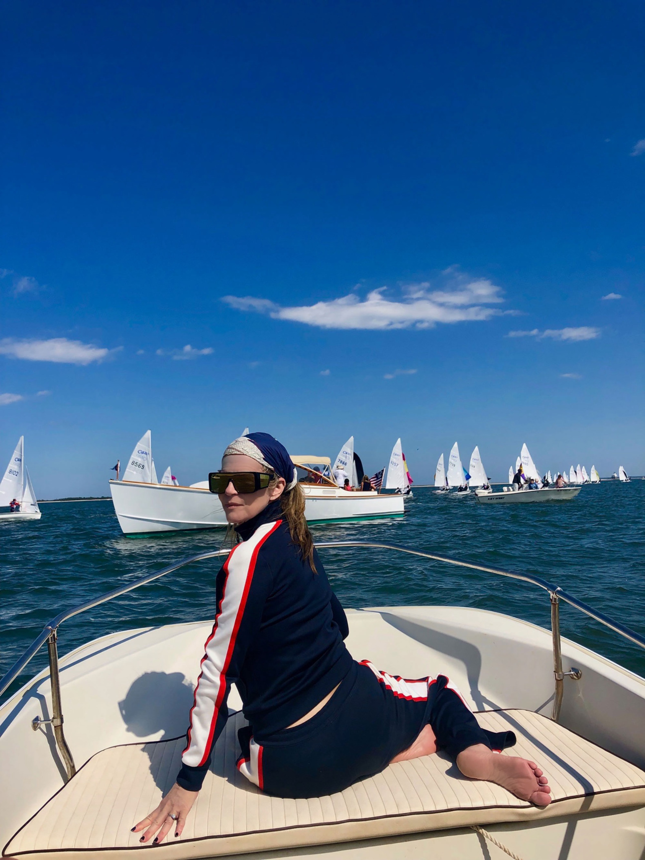 Woman at the bow of sailboat.