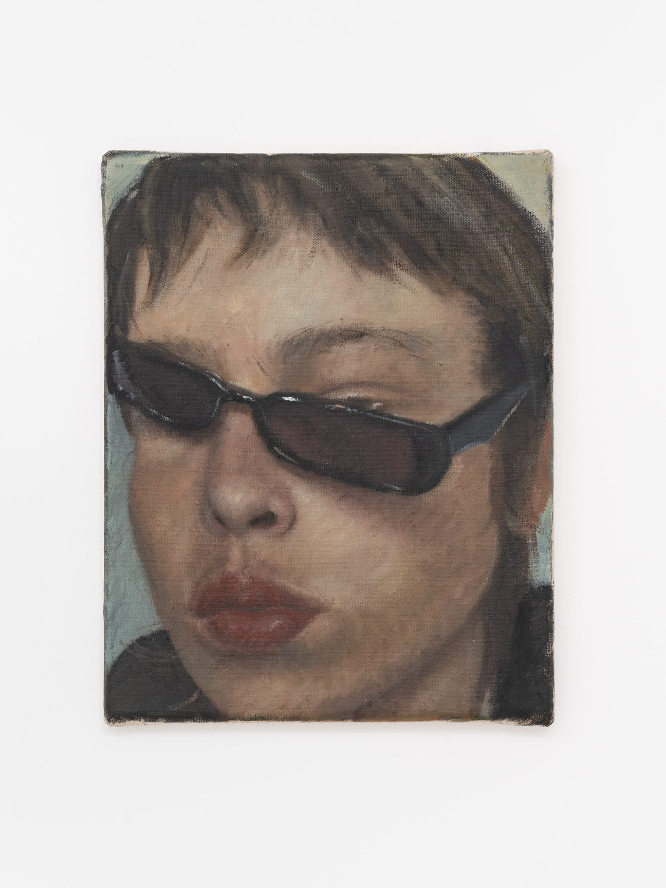 A self-portrait of artist Issy Wood with sunglasses hanging off her face.