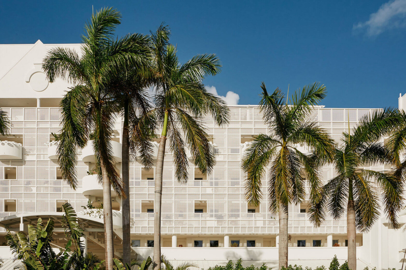 Hotel building with palm trees in foreground