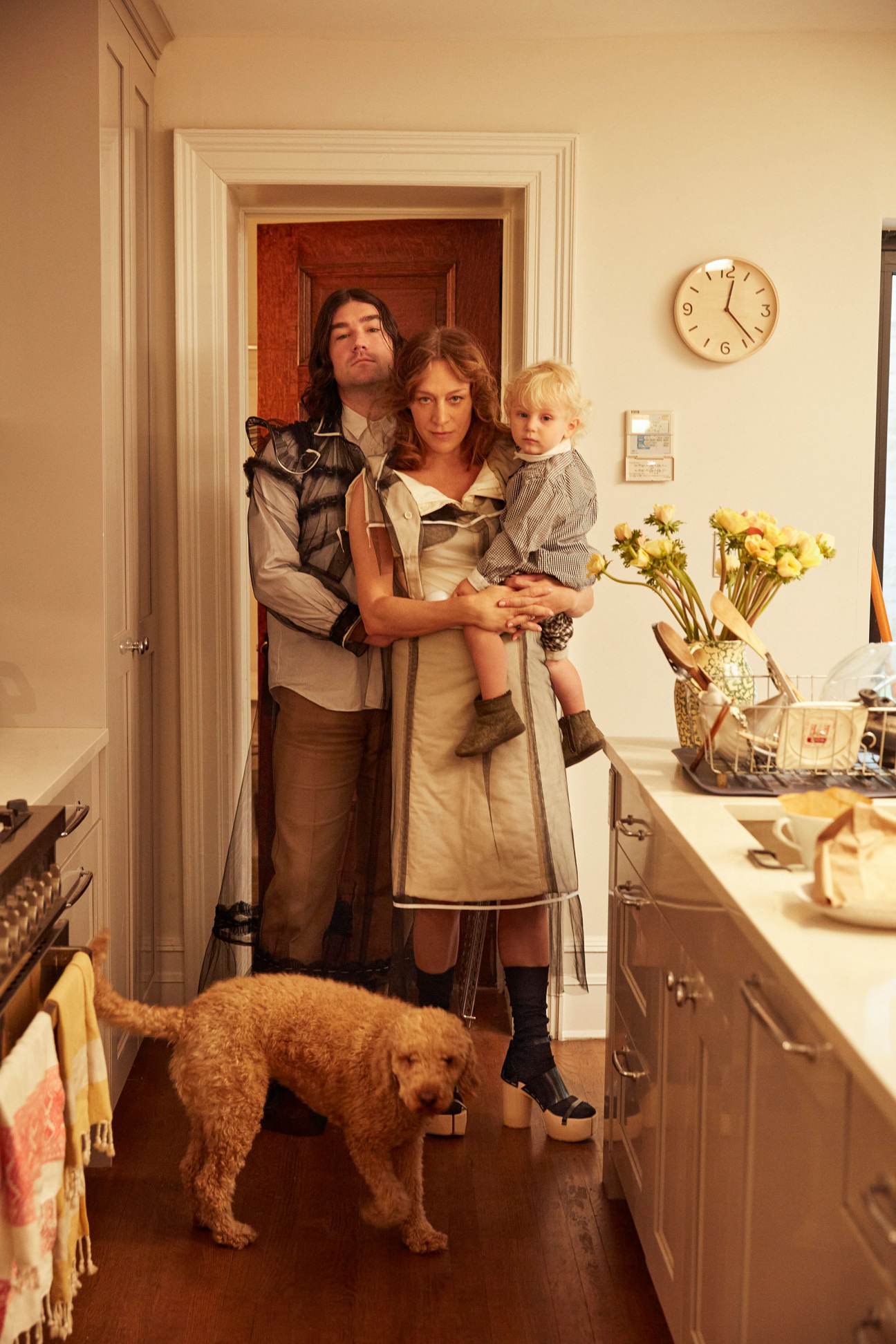 family in kitchen with baby and dog