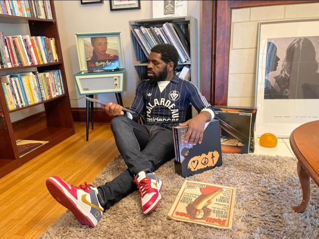 man on floor looking at records