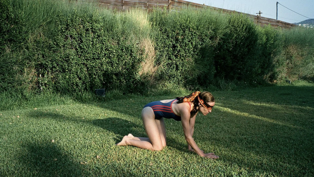 Dogtooth-woman-crawling-on-grass