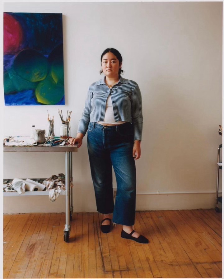 person standing with painting and table