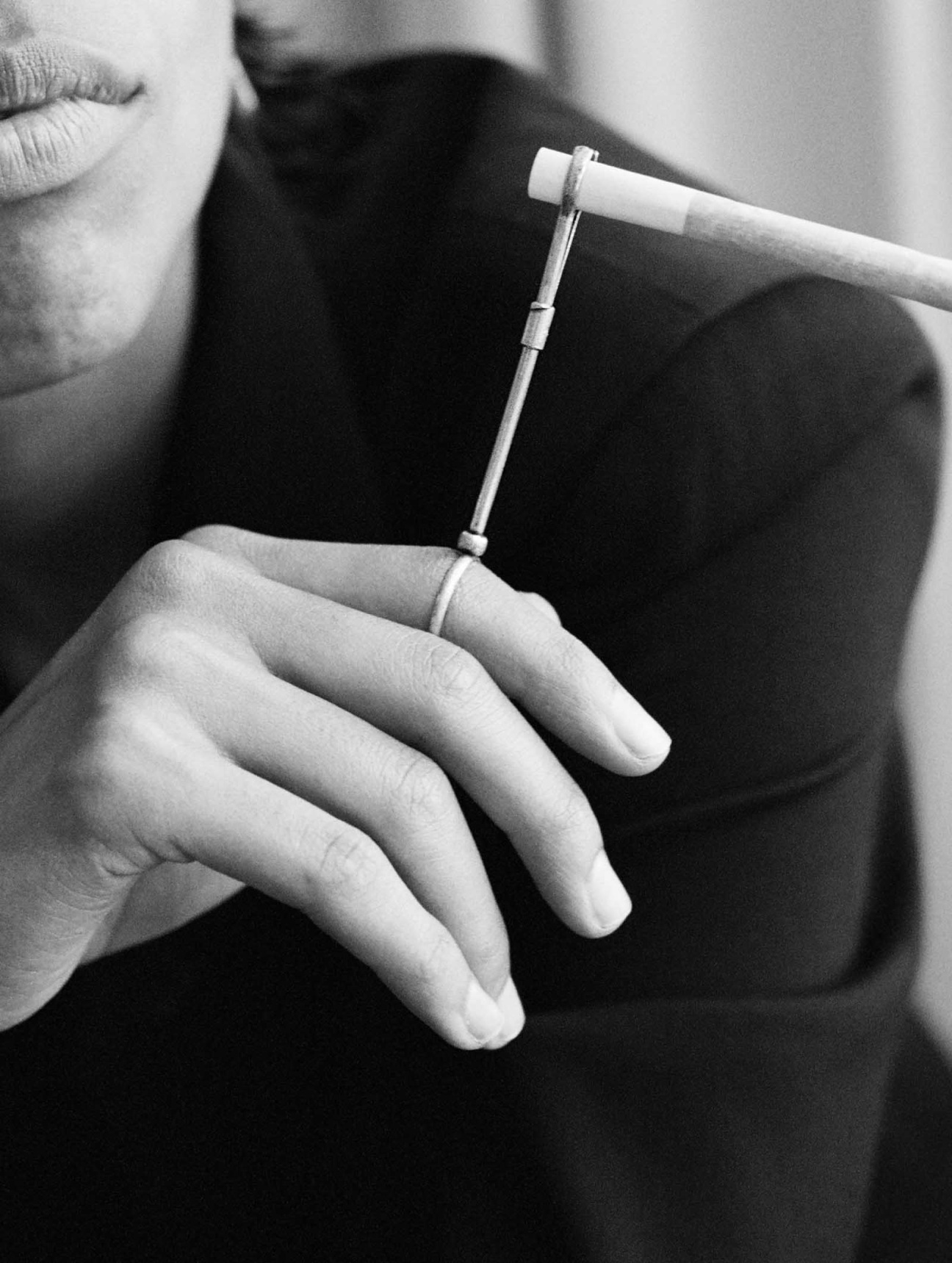 Black and white image of a woman holding a joint holder